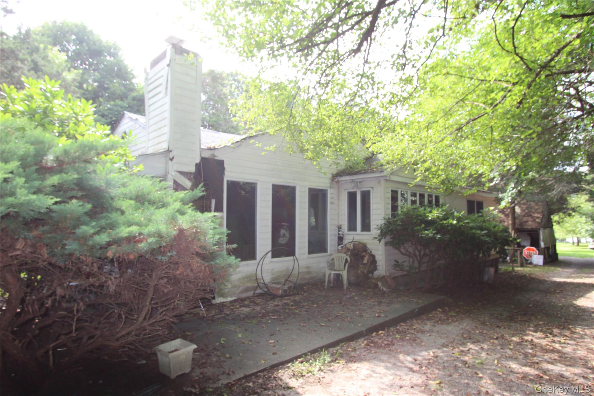 59 Dyke Road East Setauket, NY 11733 - Photo 4 of 21 a front view of a house with garden
