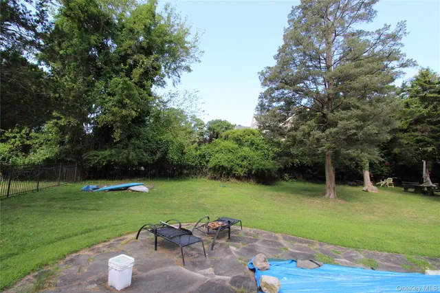 a view of a backyard with swimming pool