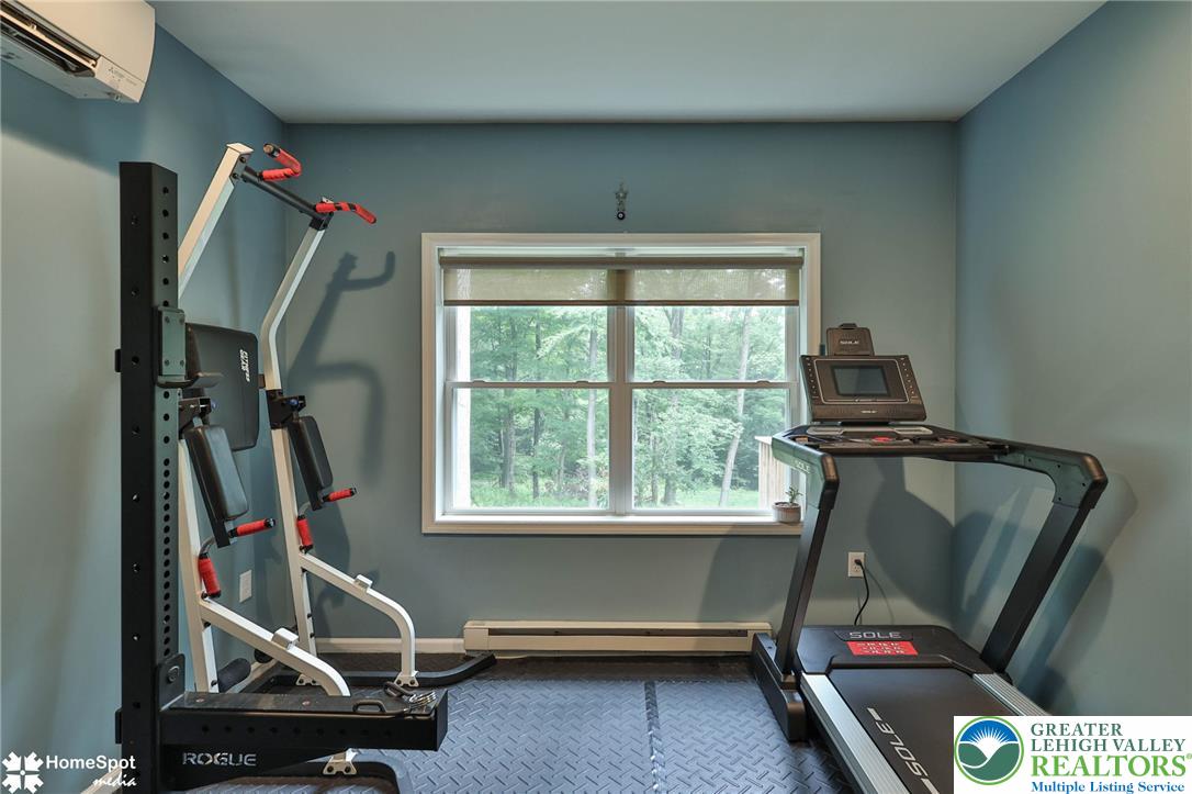 318 Church Road Kunkletown, PA 18058 - Photo 39 of 51 A dedicated home gym space offers invigorating workouts with a refreshing tree-filled outdoor view.