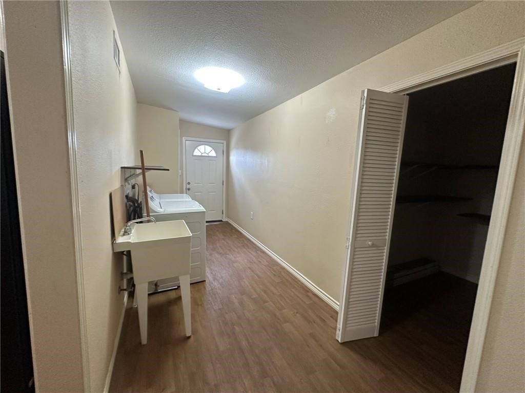 104 2nd Street Gregory, TX 78374 - Photo 13 of 27 a view of a hallway with wooden floor and furniture
