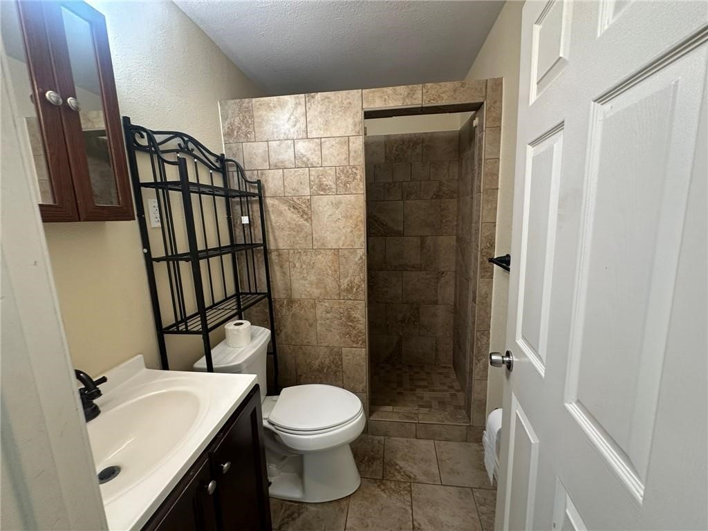 104 2nd Street Gregory, TX 78374 - Photo 21 of 27 a bathroom with a toilet sink and shower