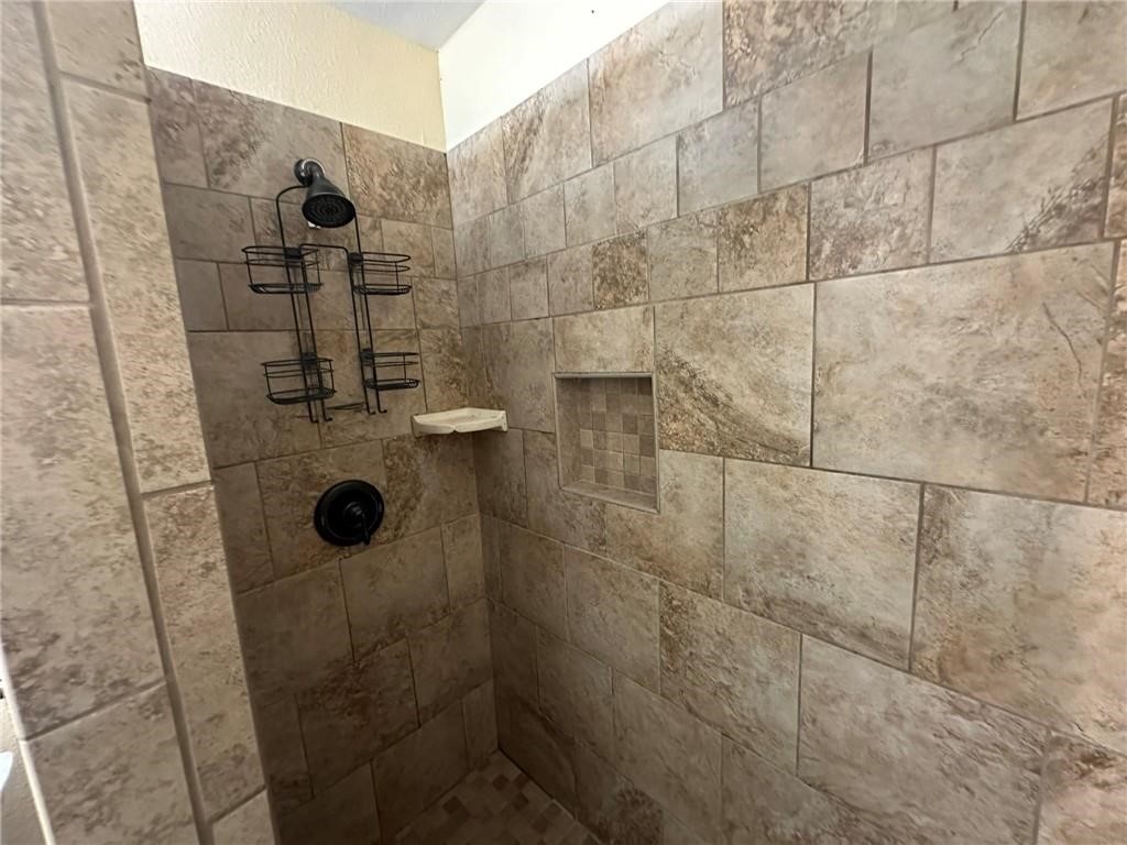 104 2nd Street Gregory, TX 78374 - Photo 23 of 27 a bathroom with a shower