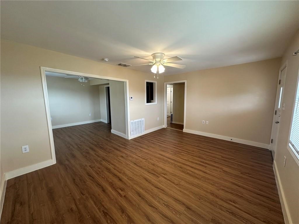104 2nd Street Gregory, TX 78374 - Photo 3 of 27 wooden floor in an empty room with a window
