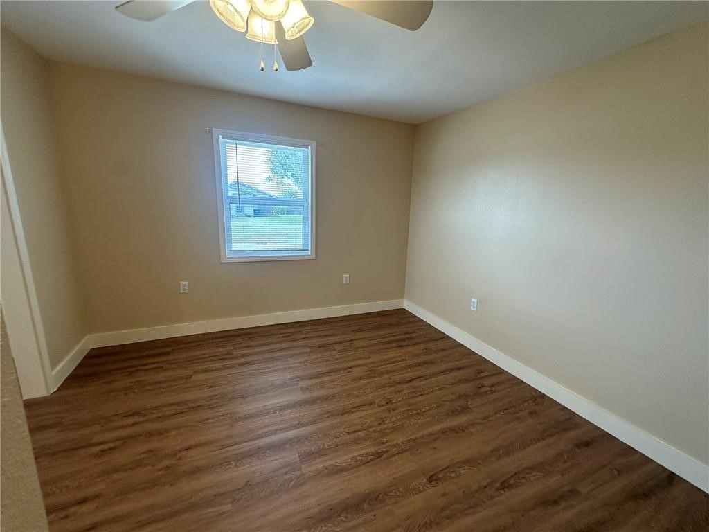 104 2nd Street Gregory, TX 78374 - Photo 8 of 27 a view of an empty room with wooden floor and a window