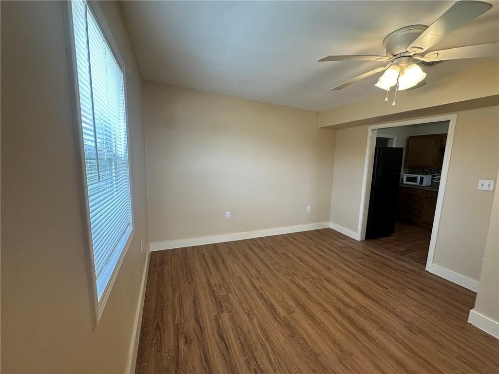 104 2nd Street Gregory, TX 78374 - Photo 9 of 27 an empty room with wooden floor and windows
