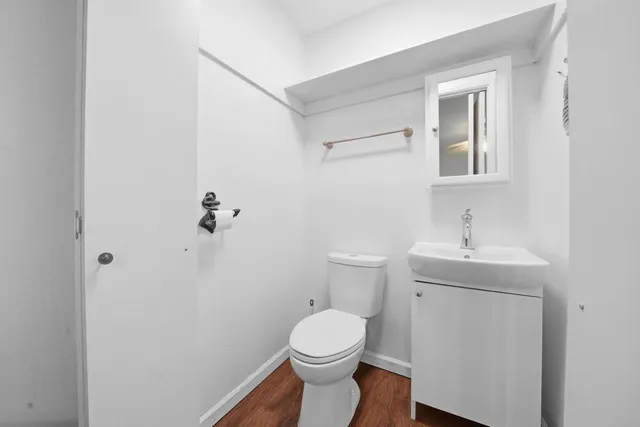 a bathroom with a sink a toilet and mirror