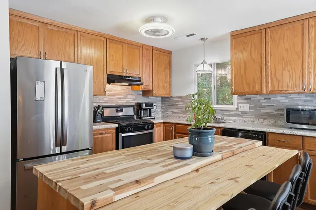 a kitchen with a refrigerator and a sink