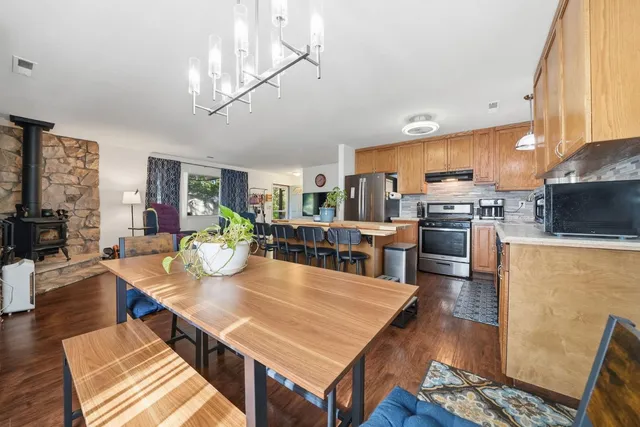 a living room with stainless steel appliances kitchen island granite countertop furniture and a kitchen view