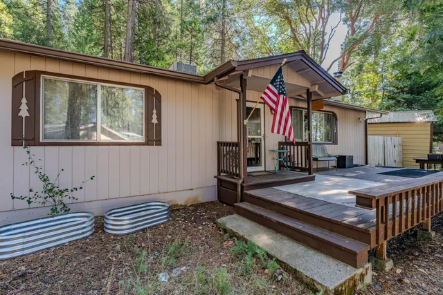 a view of a house with backyard and sitting area