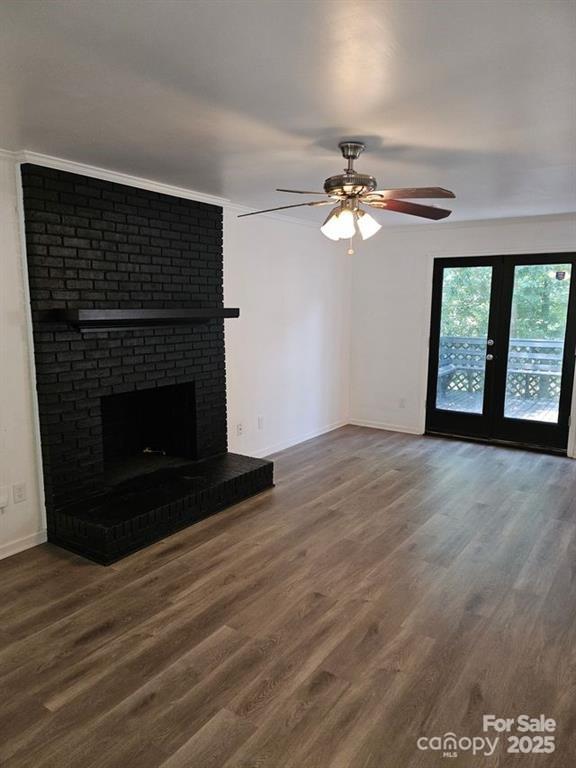2819 Royal Ridge Lane Charlotte, NC 28212 - Photo 11 of 15 a view of a livingroom with a fireplace a ceiling fan and wooden floor