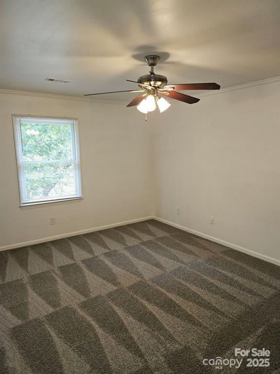 2819 Royal Ridge Lane Charlotte, NC 28212 - Photo 9 of 15 an empty room with wooden floor fan and windows