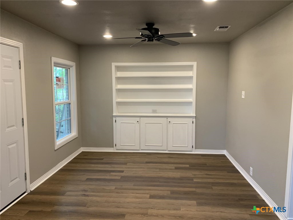 1902 State Highway 95 Little River-Academy, TX 76554 - Photo 15 of 20 a view of an empty room with a window and wooden floor