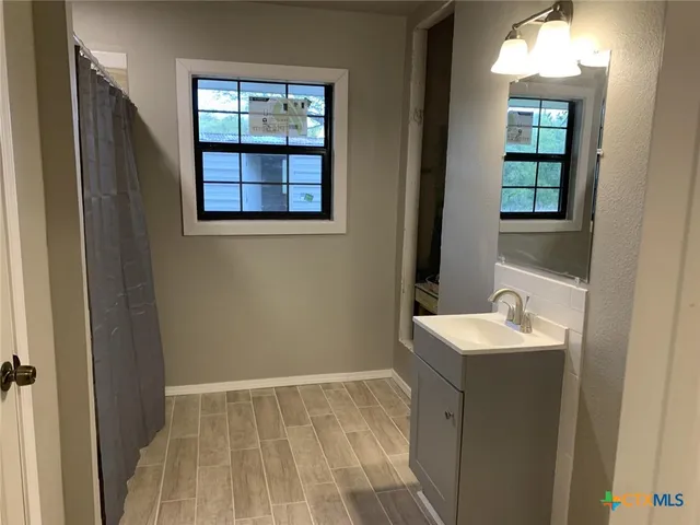 a bathroom with a sink and a mirror