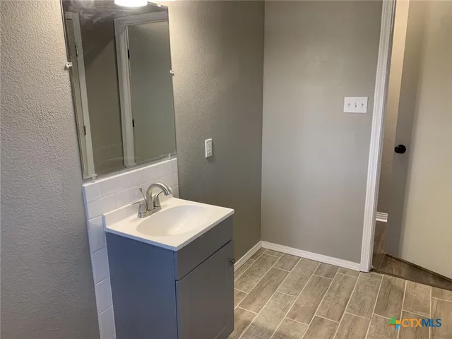 a bathroom with a sink and a mirror
