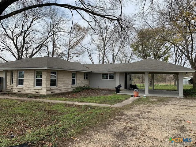 a house that has a tree in front of it