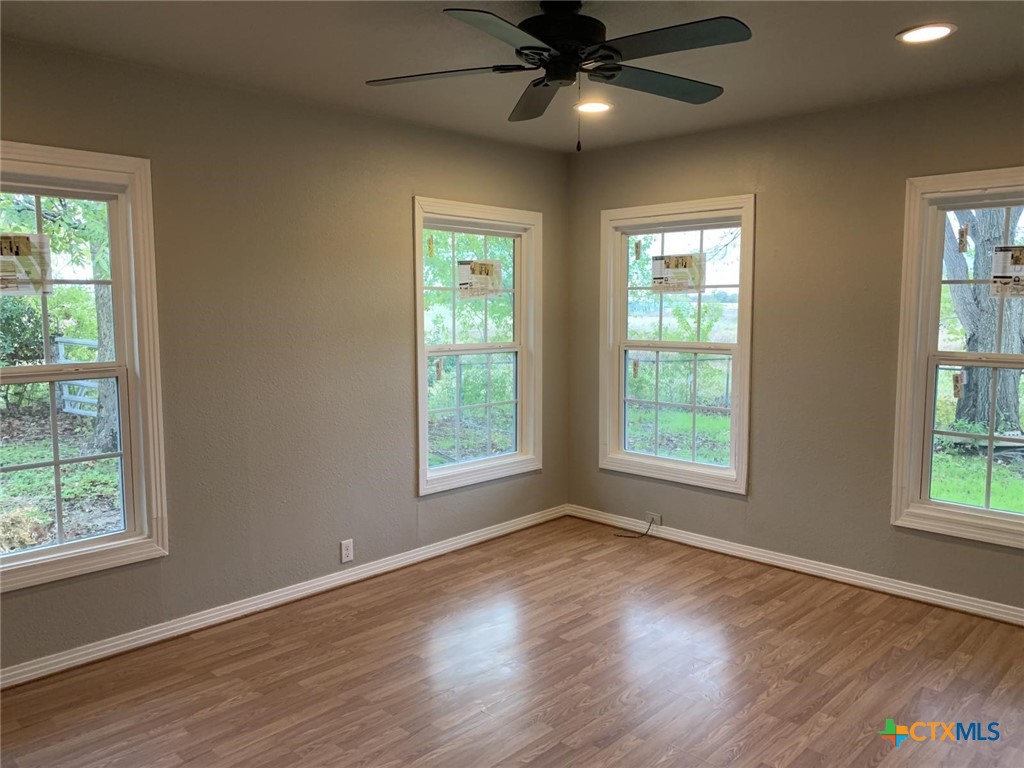 1902 State Highway 95 Little River-Academy, TX 76554 - Photo 9 of 20 a view of an empty room with wooden floor and a window
