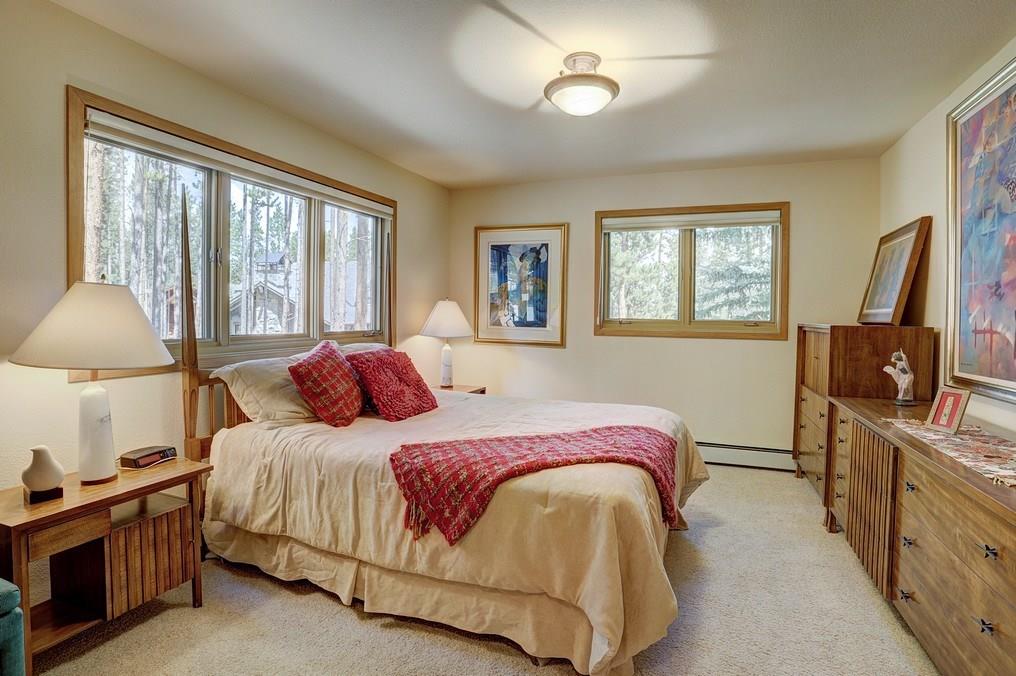 213 4 O'Clock Run Road Breckenridge, CO 80424 - Photo 14 of 34 a bedroom with a bed and a flat tv screen on the dresser