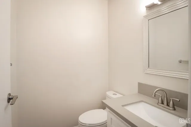 a white toilet sitting next to a bathroom sink