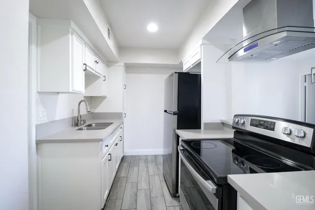 a kitchen with a sink stove and refrigerator