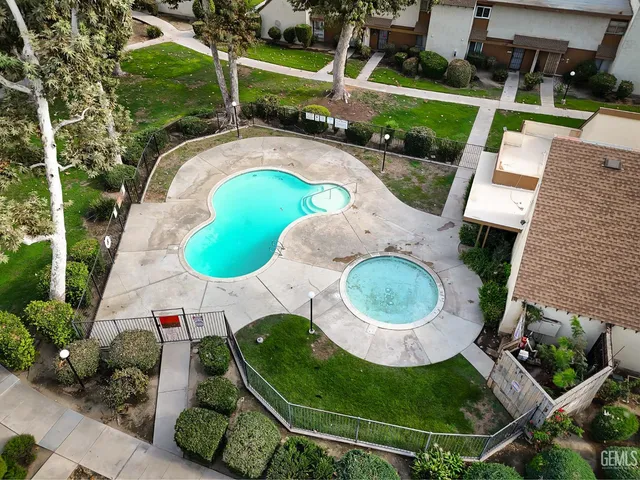 an aerial view of a house with garden space and street view