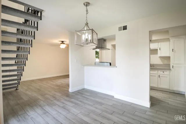 a view of a kitchen cabinets and wooden floor