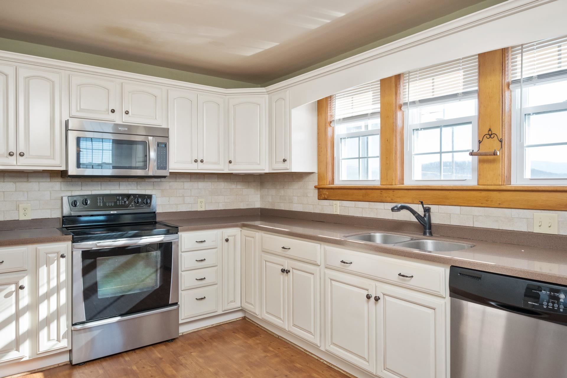 7720 Port Republic Road Port Republic, VA 24471 - Photo 20 of 35 a kitchen with granite countertop white cabinets and stainless steel appliances