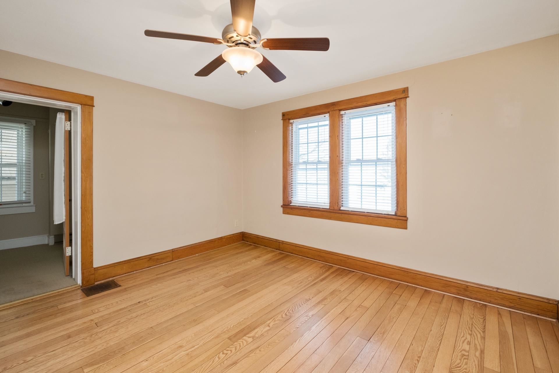 7720 Port Republic Road Port Republic, VA 24471 - Photo 26 of 35 an empty room with wooden floor chandelier fan and windows