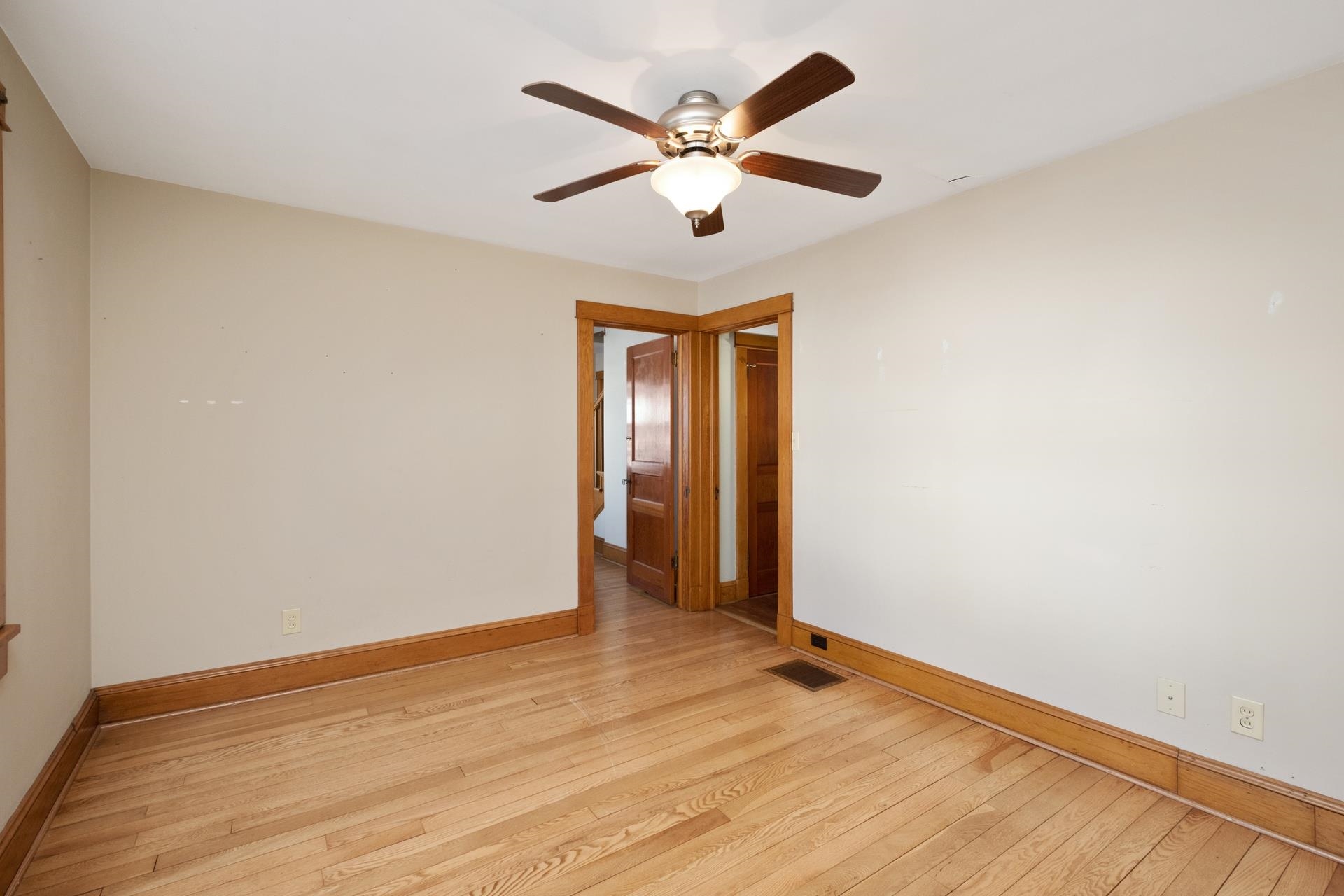 7720 Port Republic Road Port Republic, VA 24471 - Photo 35 of 35 an empty room with wooden floor and ceiling fan