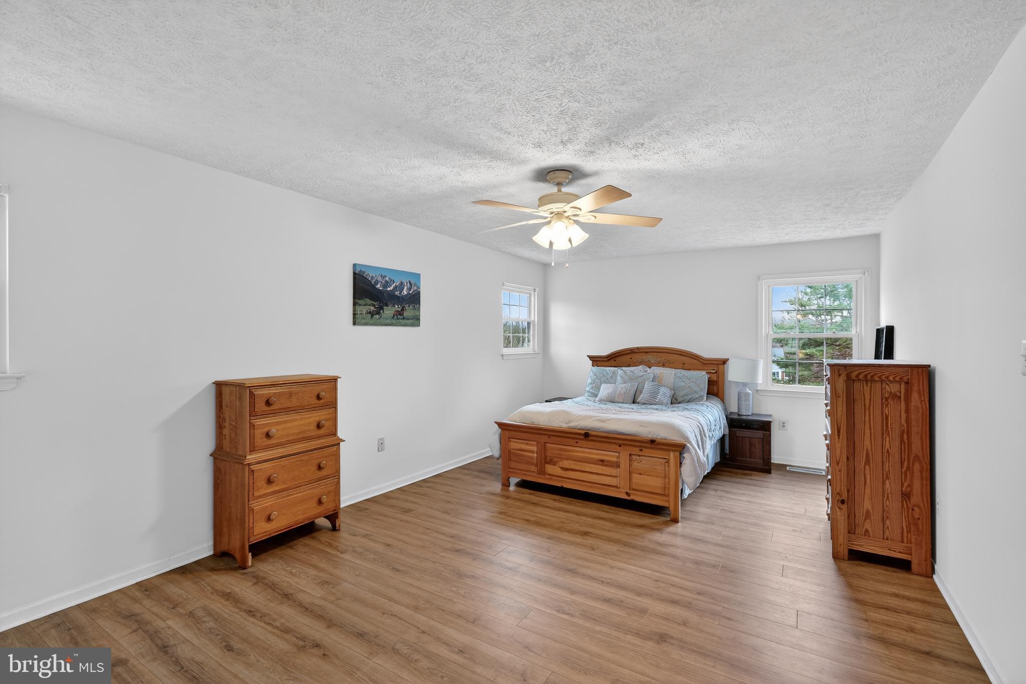7200 Beachway Court Springfield, VA 22153 - Photo 13 of 31 a spacious bedroom with a bed and a chair