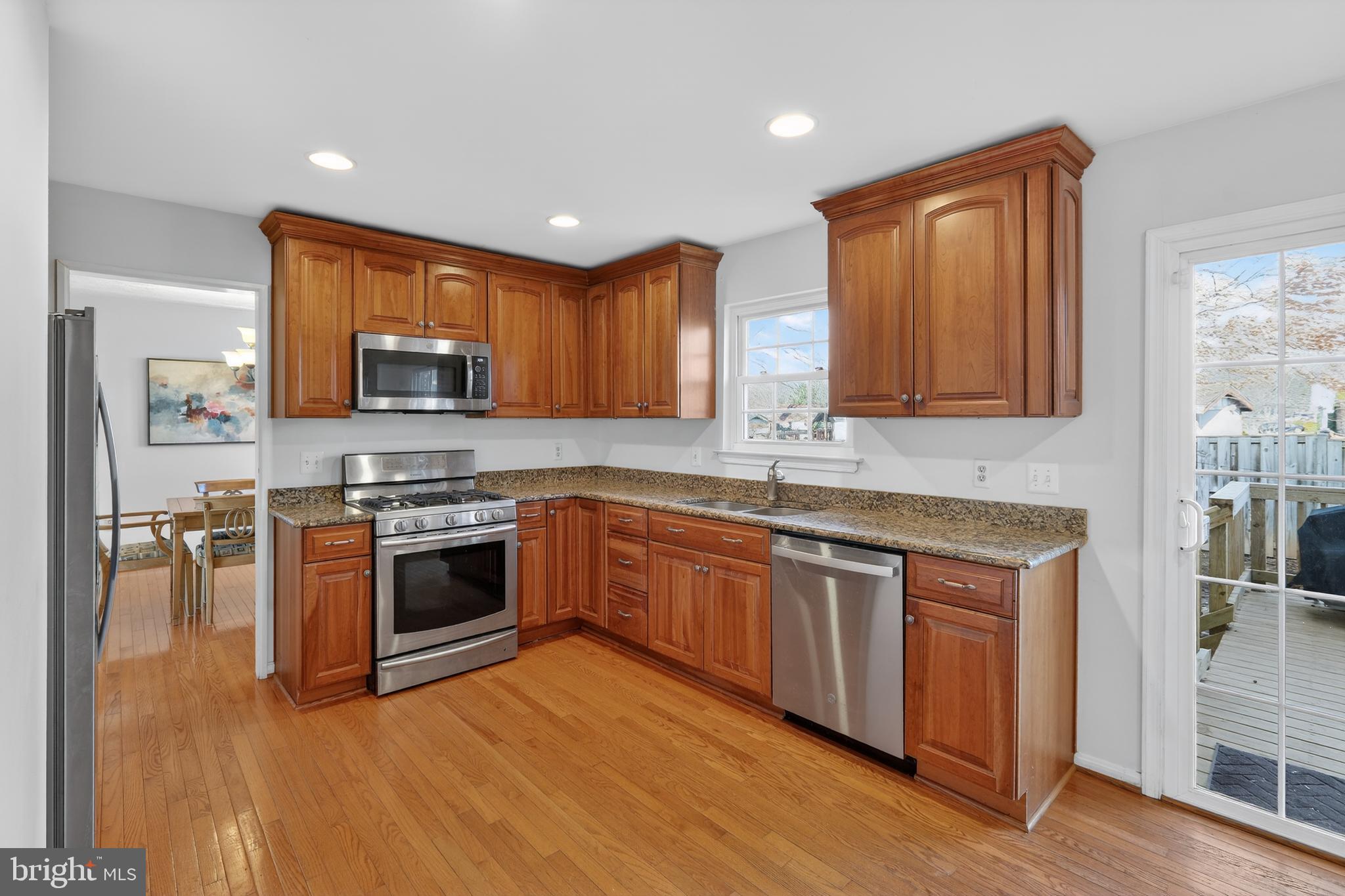 7200 Beachway Court Springfield, VA 22153 - Photo 4 of 31 a kitchen with stainless steel appliances granite countertop a stove a sink and a microwave