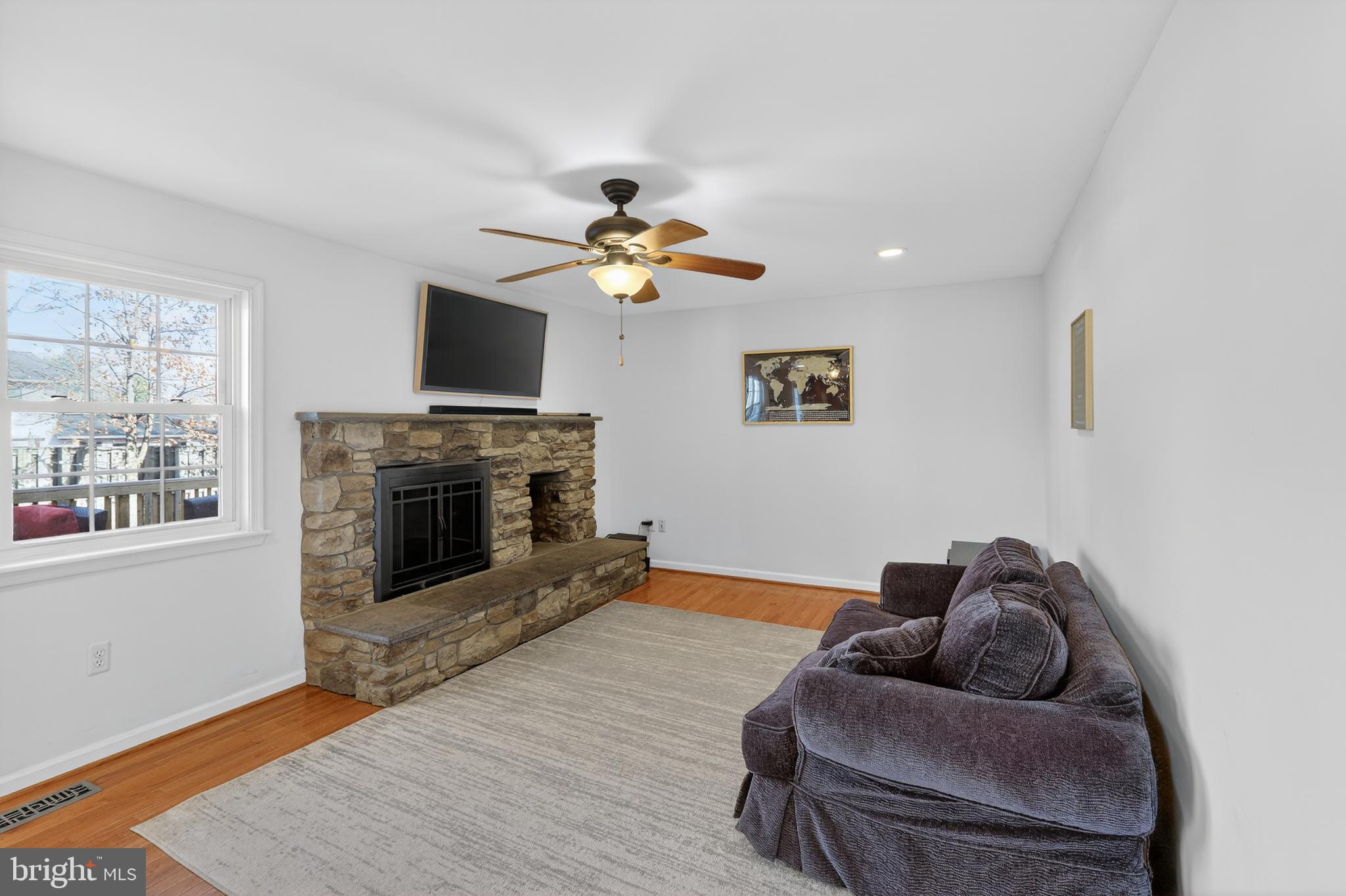 7200 Beachway Court Springfield, VA 22153 - Photo 6 of 31 a living room with furniture a fireplace and a flat screen tv