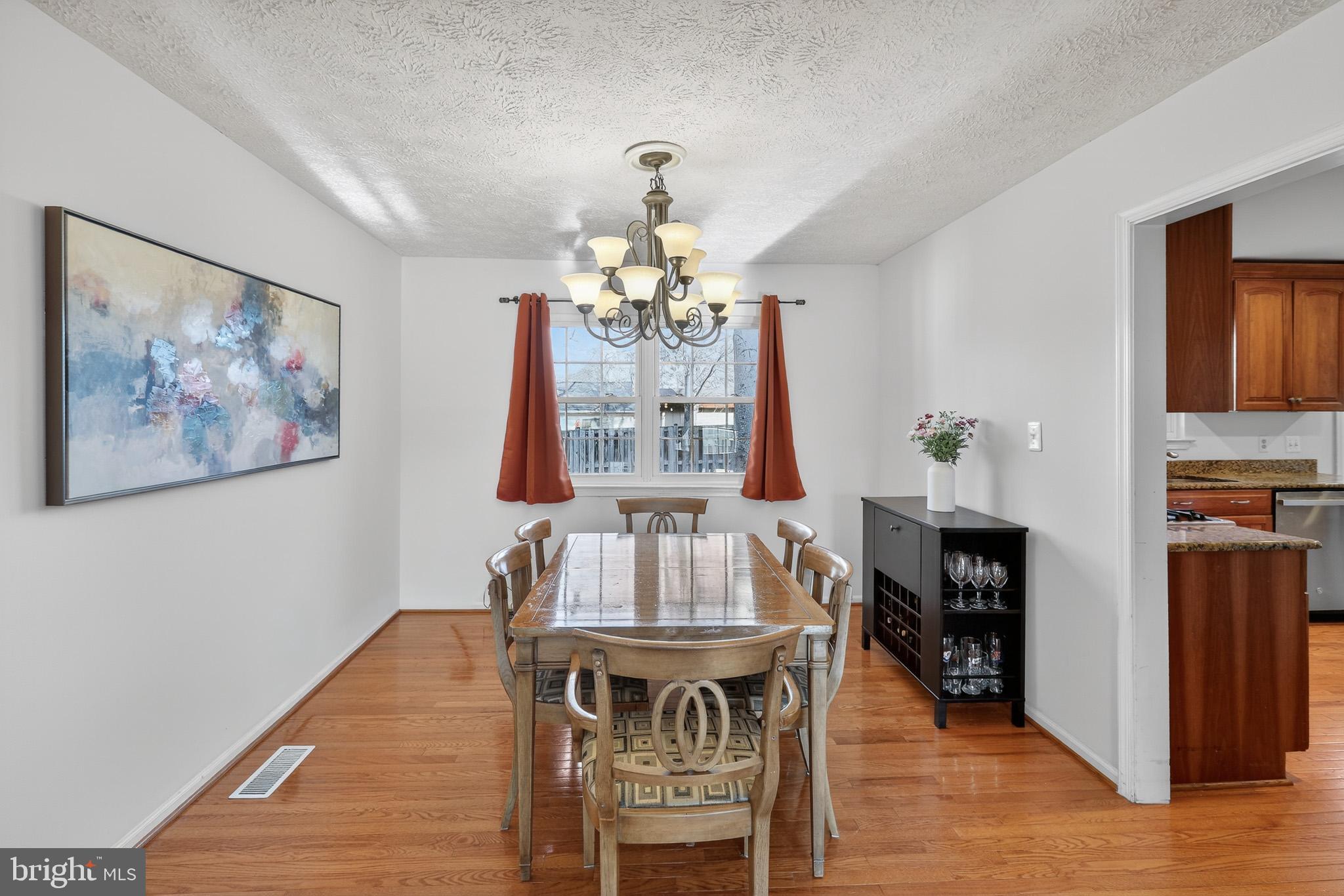 7200 Beachway Court Springfield, VA 22153 - Photo 8 of 31 a view of a dining room with furniture wooden floor and chandelier