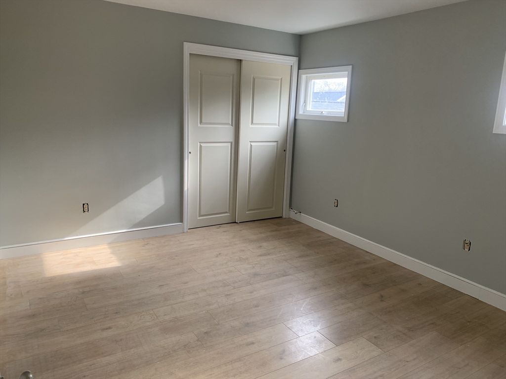 3161 Cranberry Highway, Unit 2 Wareham, MA 02538 - Photo 5 of 9 an empty room with closet and windows