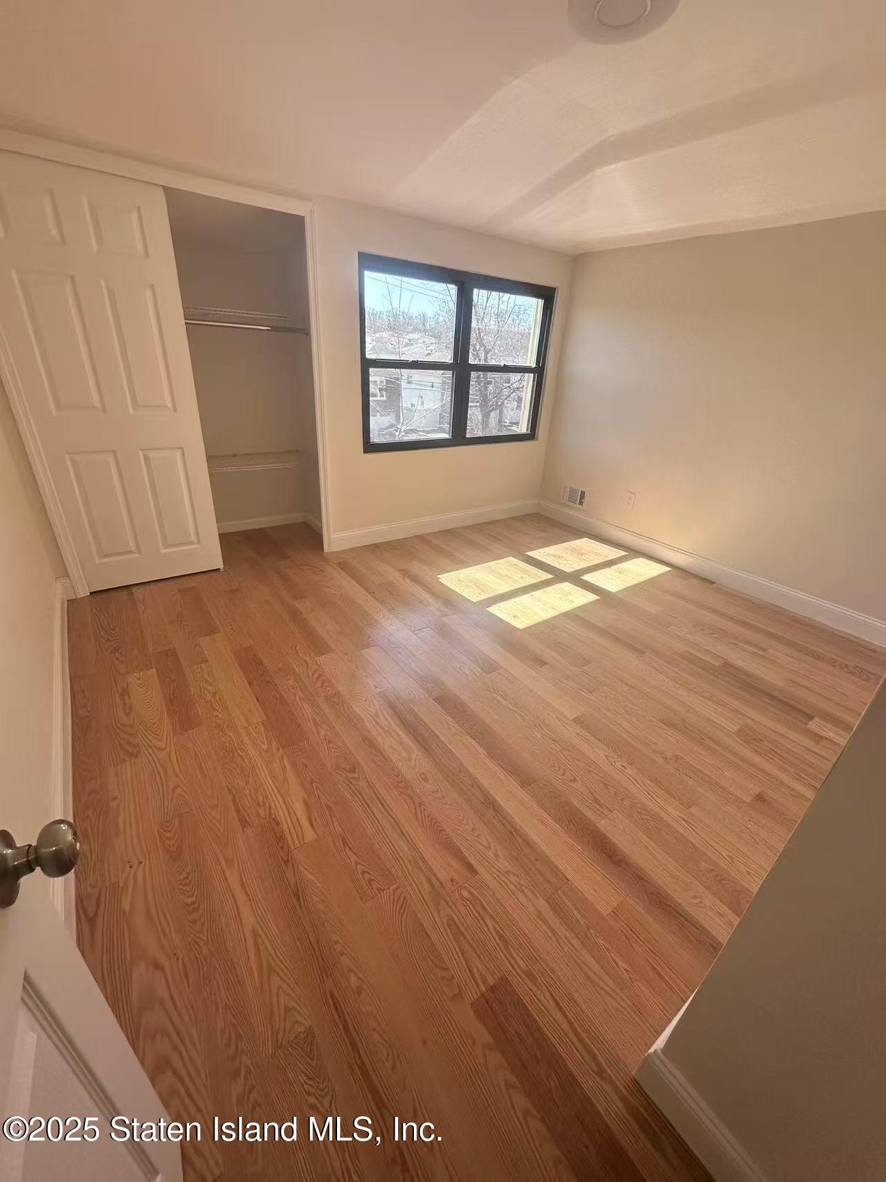 19 Drumgoole Road East Staten Island, NY 10312 - Photo 7 of 13 an empty room with windows