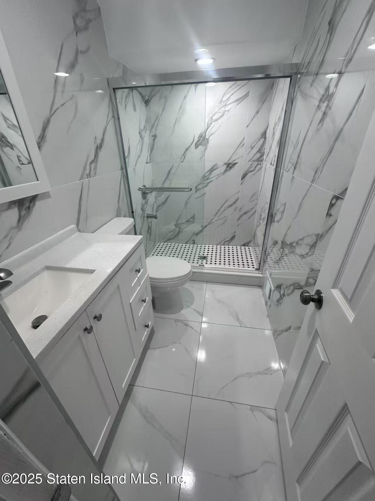 19 Drumgoole Road East Staten Island, NY 10312 - Photo 9 of 13 a bathroom with a sink a toilet and shower