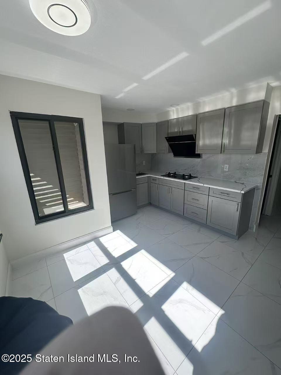 19 Drumgoole Road East Staten Island, NY 10312 - Photo 10 of 13 a kitchen with stainless steel appliances kitchen island granite countertop a refrigerator