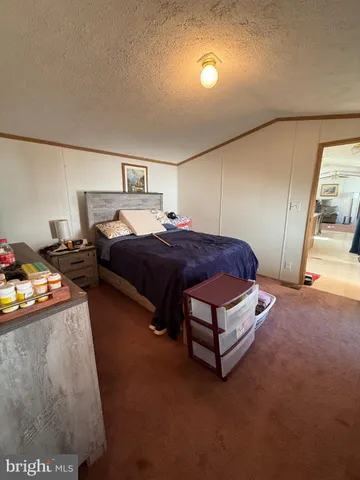 a bedroom with a bed and a lamp with the wooden floor