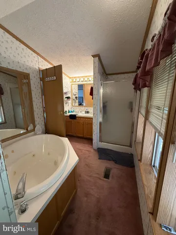 a bathroom with a tub sink and shower