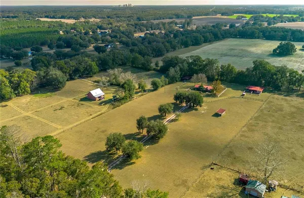 an aerial view of a houses with a yard