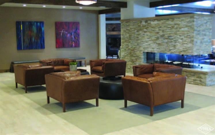 210 Week 27 Offerson Road, Unit 310 WEEK 27 Beaver Creek, CO 81620 - Photo 3 of 7 a living room with furniture and a fireplace