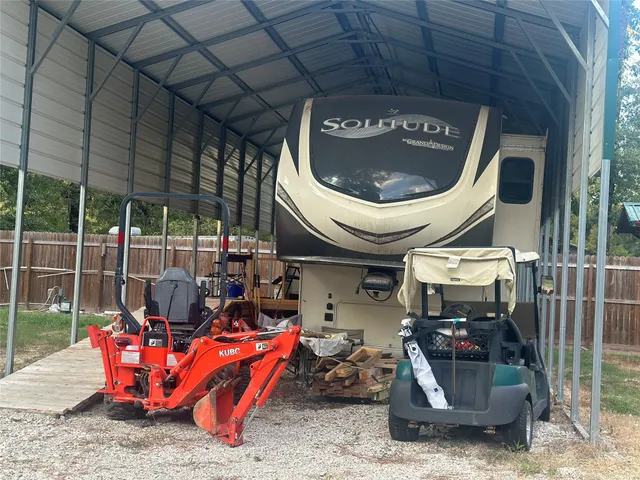 a backyard of a house with garden and swing