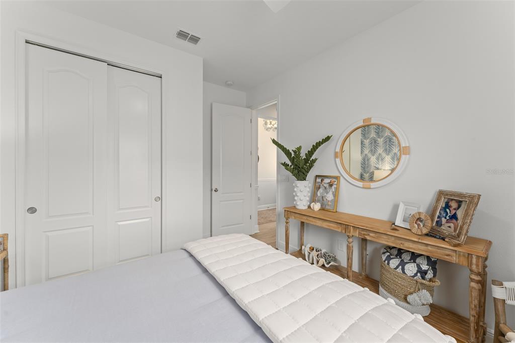 2983 Rapollo Lane Apopka, FL 32712 - Photo 11 of 62 a bedroom with a bed a mirror and a window