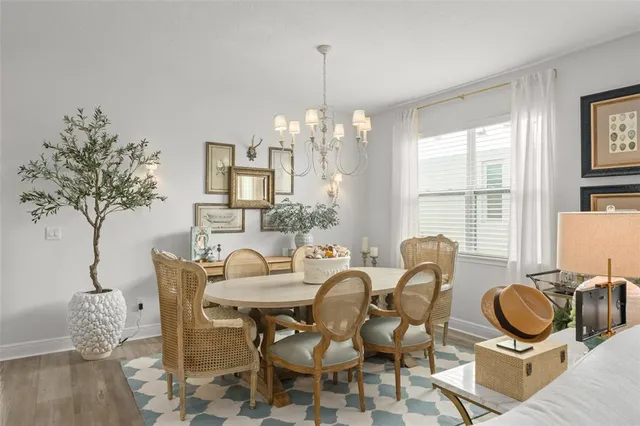 a living room with furniture a flat screen tv and a floor to ceiling window