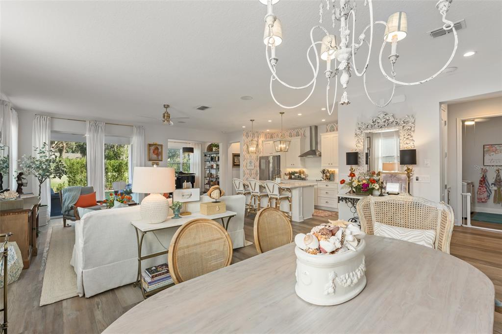 2983 Rapollo Lane Apopka, FL 32712 - Photo 17 of 62 a living room with furniture a chandelier and a large mirror