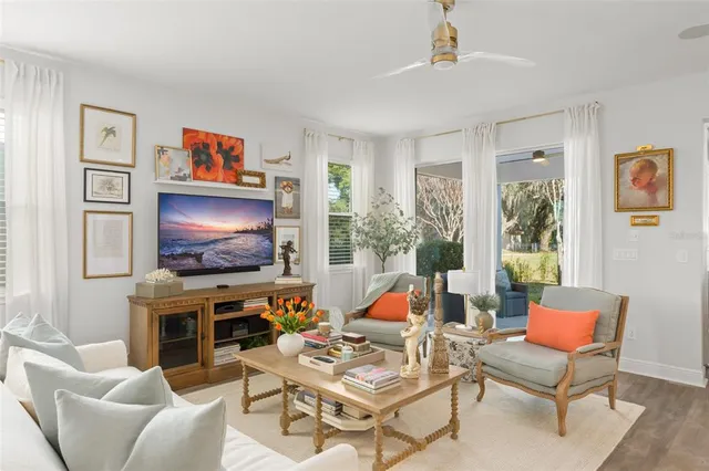 a living room with furniture and kitchen view