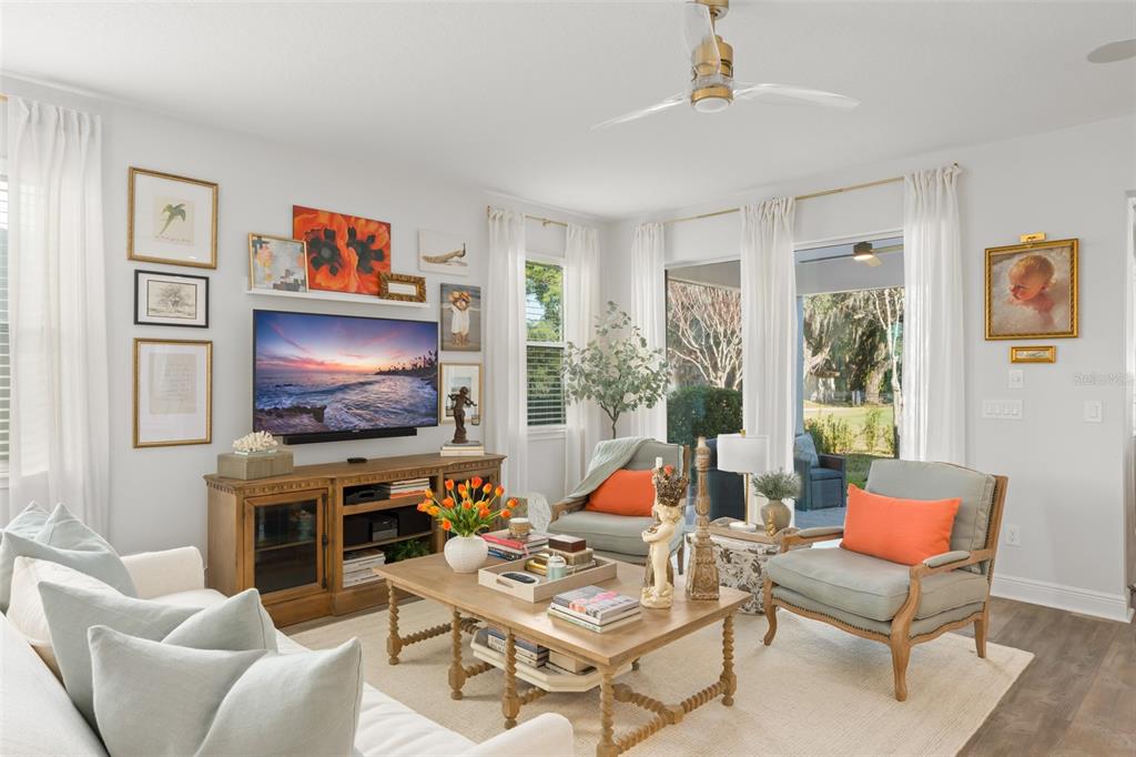 2983 Rapollo Lane Apopka, FL 32712 - Photo 19 of 62 a living room with furniture a flat screen tv and a floor to ceiling window