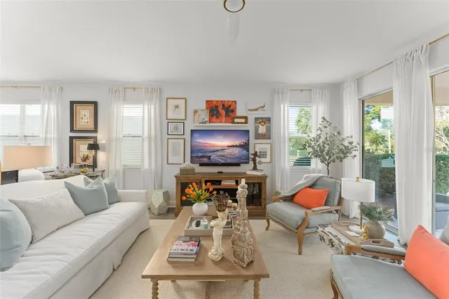 a kitchen with stainless steel appliances a dining table chairs refrigerator and cabinets