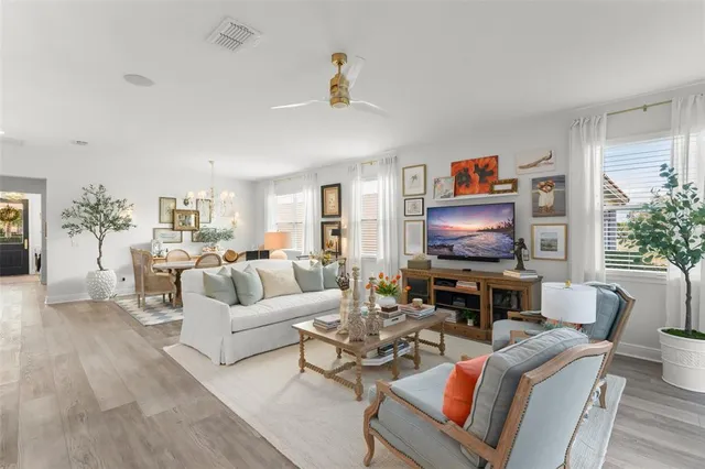 a kitchen with stainless steel appliances granite countertop a table chairs and a refrigerator