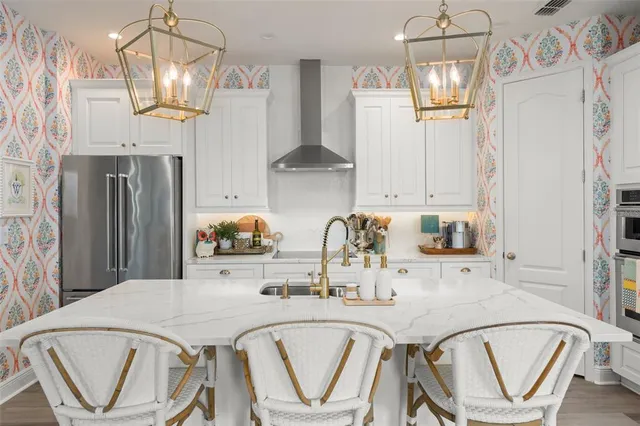 a kitchen with white cabinets and sink