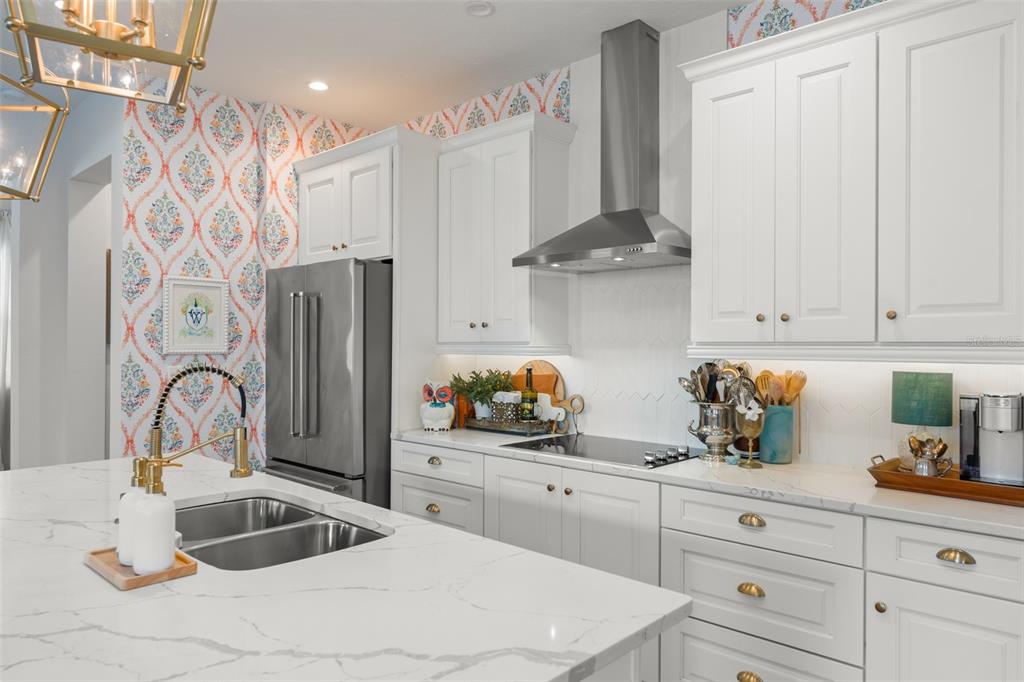 2983 Rapollo Lane Apopka, FL 32712 - Photo 25 of 62 a kitchen with stainless steel appliances a sink and refrigerator